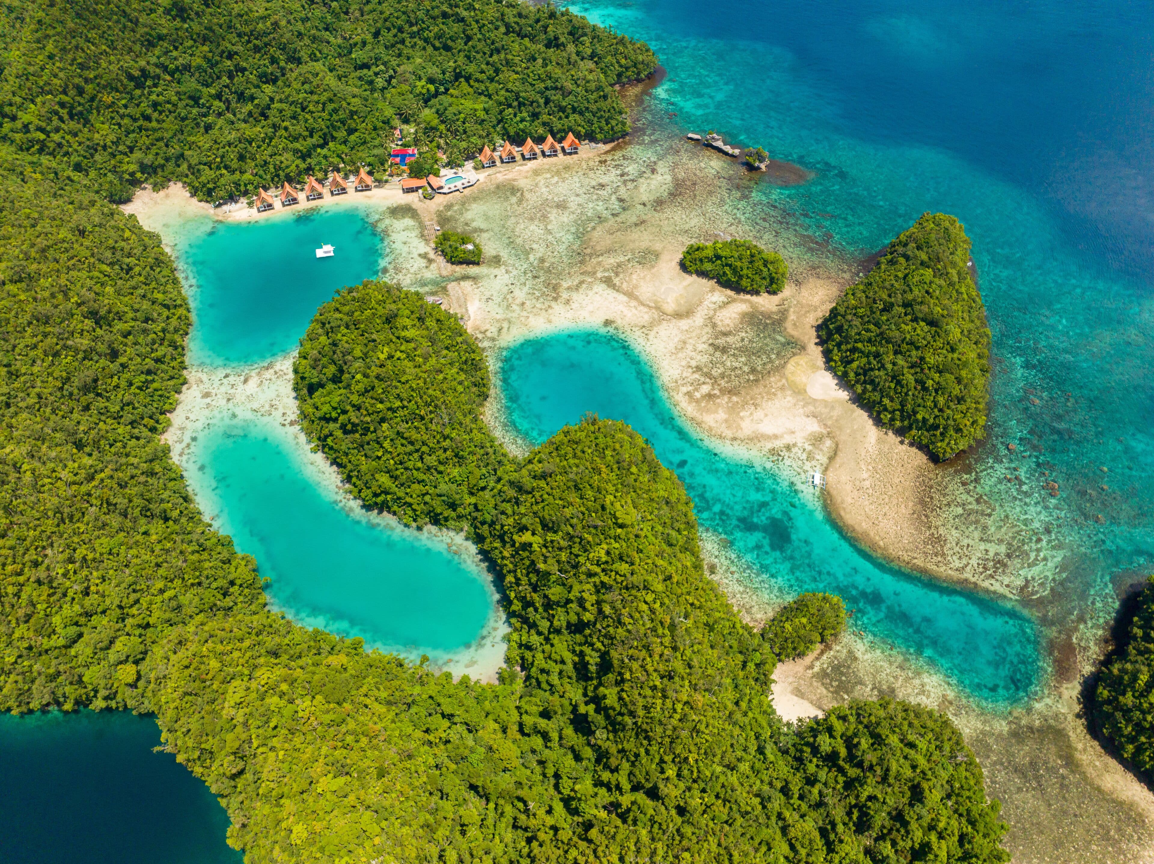 Aerial view of Bucas Grande's turquoise lagoons winding between dense limestone islands
